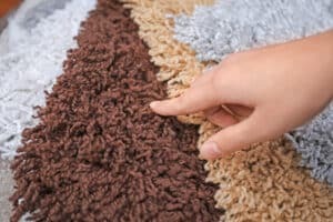 woman points at carpet selection