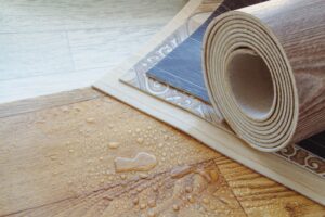 roll of laminate an water on the floor
